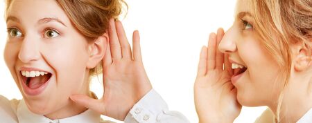 Two young women talk and listen with hand to mouth and ear