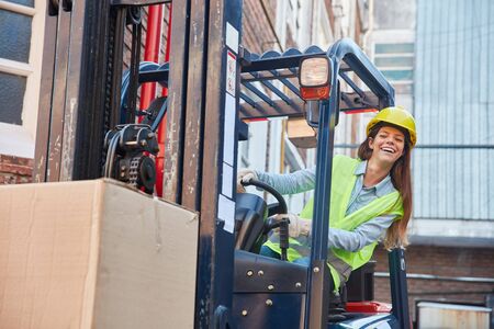 Young woman in logistics. Training to forklift driver on the forkliftの写真素材