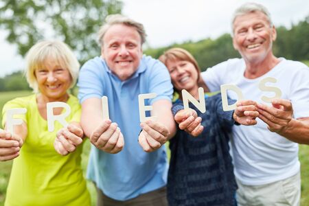 Seniors form the word Friends out of letters as a sign of communityの写真素材