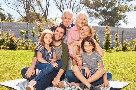 Happy family with three generations together in the summer in the garden