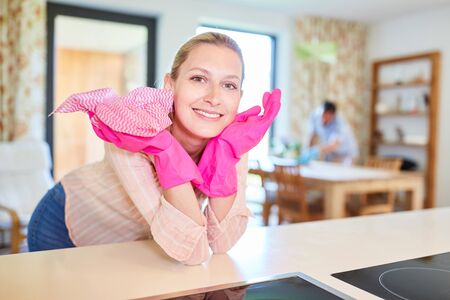 Smiling cleaning lady or cleaner with swab in the apartmentの写真素材
