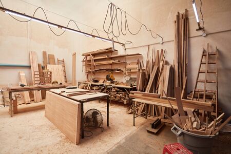 Joinery or carpentry with a workbench and stock of woodの写真素材
