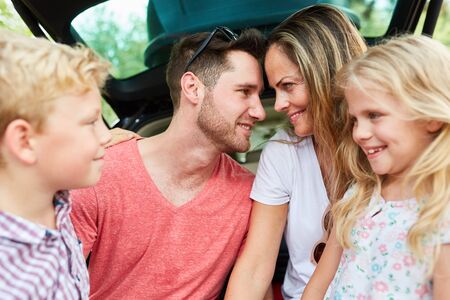 Parents couple in loving harmony together with two children on vacation tripの写真素材