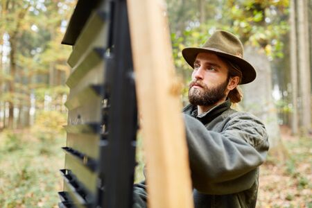 Forester on a bark beetle trap as pest control and forest care