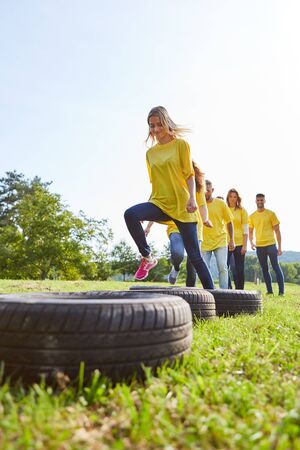 Young team in a sports game or competition with car tiresの写真素材