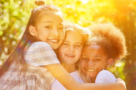 Integration by three happy girls in the summer in natureの写真素材