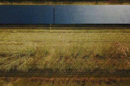 Solar system next to railway tracks from above in summerの写真素材