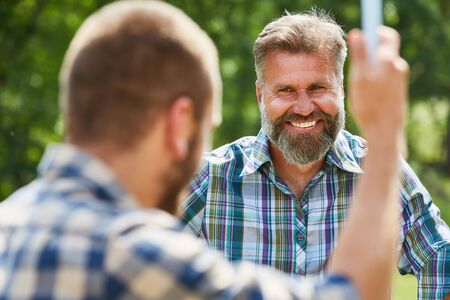 Man as a happy volunteer activist along with another helperの写真素材