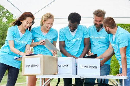 Voluntary Volunteer Team collects and registers donations in donation boxesの写真素材