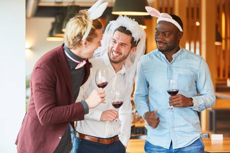 Friends in funny disguise celebrate a bachelor party in a bar