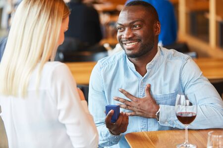 African man gives ring to girlfriend and makes her a marriage proposal