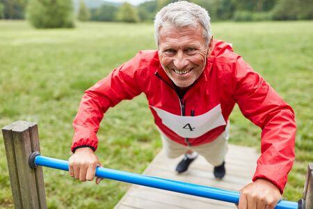 Active senior man on the trim you path on a gym equipment