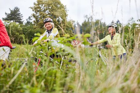 Group of seniors cycling in nature on a bike ride or bike rideの写真素材