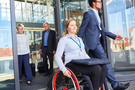 Disabled businesswoman in a wheelchair after a meeting or after workの写真素材