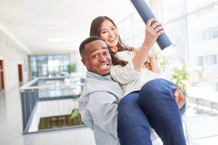 Happy interracial couple celebrate university diploma completionの写真素材
