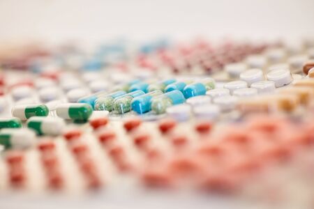 Many colorful medicines are sorted in blister packaging next to each other