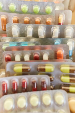 A pile of colorful medicines in blister packaging
