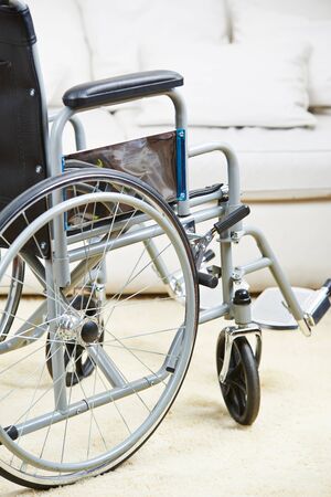 Empty wheelchair is standing in a living roomの写真素材