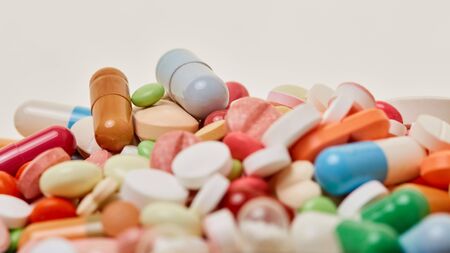 Heap of various colorful medicines drugs and pills as a close-up
