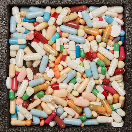 Many colorful pills tablets and medication from above
