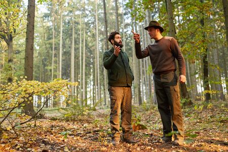 Forester and intern together in the forest on a patrolの写真素材