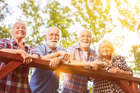 Group of seniors taking a break while hiking in the summer