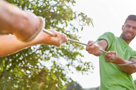 Young people train strength and fitness while tug-of-war at a sports event