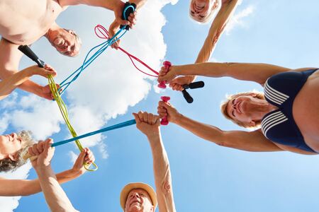 Seniors with skipping rope in the circle do rehab gymnastics together in natureの写真素材