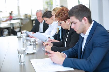 Businesspeople sit together at the table in the conference room during a negotiation