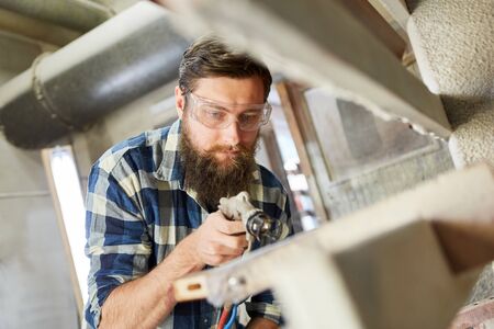 Varnishers when painting wood with the spray gun or paint gunの写真素材