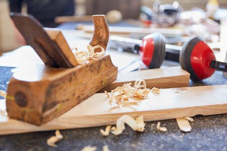 Planer as a hand tool between wood shavings of a carpentry or joinery