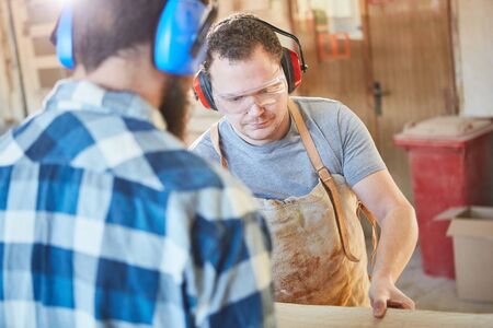 Two carpenters or carpenters work together in the carpentry workshopの写真素材