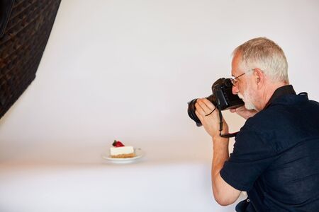 Senior photographer photographing food in the photo studioの写真素材