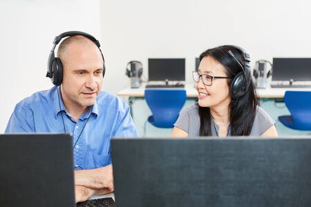 Two students or developers as a team at the laptop computer or in the language course