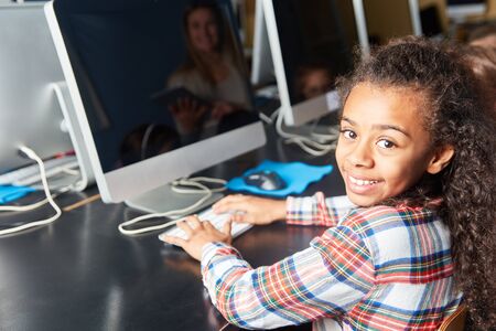 Girl enjoys elementary school computer science course at computerの写真素材