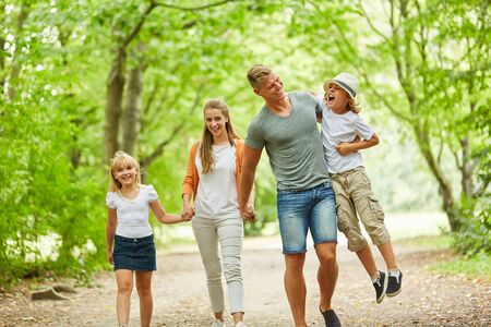 Happy family in relaxed walk in the green natureの写真素材