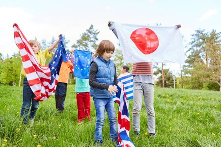 Group of children in international youth camp with different national flags