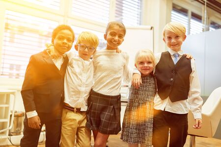 Multicultural group of children together as friends in business officeの写真素材