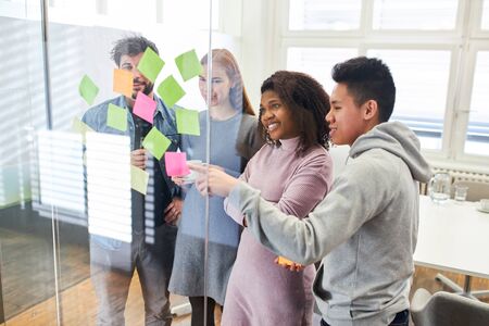Web designer brainstorming with sticky notes as a creative start-up team