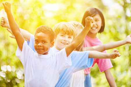Multicultural group of children celebrate a children's birthday together and playの写真素材
