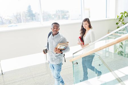 African student and asian student together as a couple in school