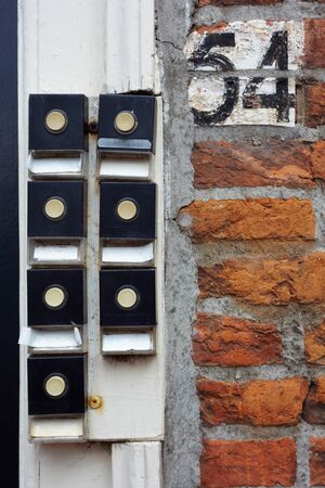 Seven doorbells at a house entrance