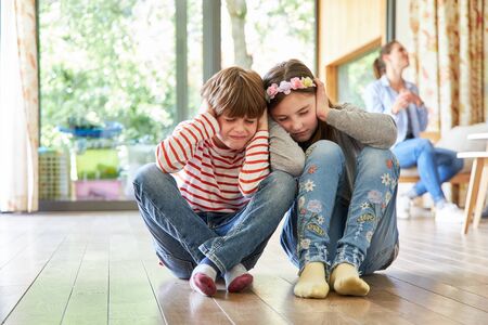 Siblings Children listen to their parents' loud argumentの写真素材