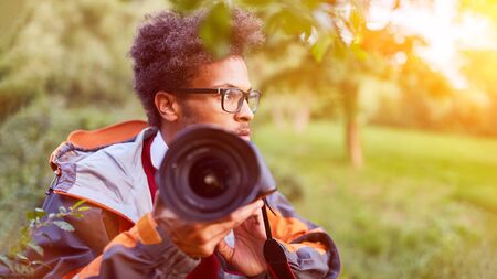 Paparrazi photographer secretly photographs for spying photos in nature