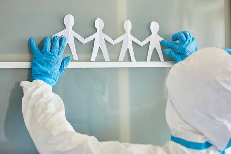 Clinic staff attached paper cut as cohesion concept in coronavirus pandemic