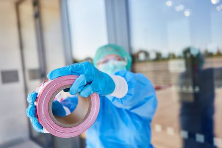 Barrier on door from closed clinic in quarantine for Covid-19 coronavirus andの写真素材