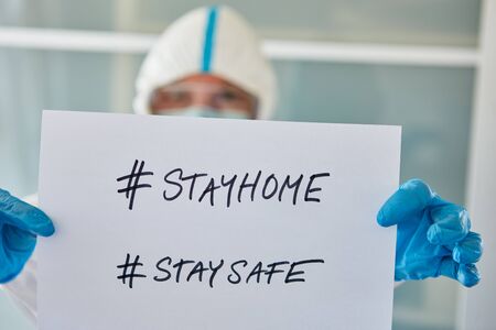 #stayhome #staysafe Message held by a clinic staff at coronavirus and Covid-19 pandemicの写真素材