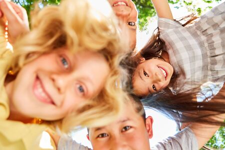 Group of kids in international kindergarten as a team in natureの写真素材