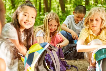 Multicultural children group with backpack on a hike