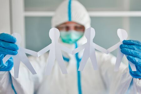 Employee holds paper cut from team as decoration in children's clinic during coronavirus epidemic